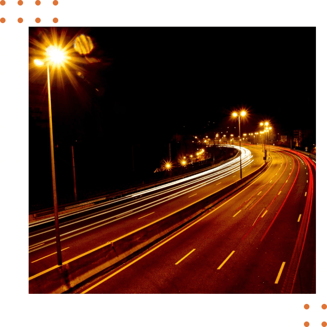 A highway with lights at night and a green dotted background